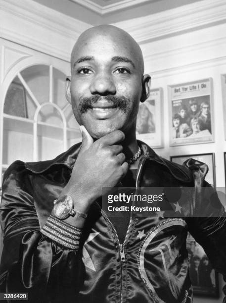Errol Brown, singer with pop funk group Hot Chocolate, who were presented with a silver disc by author Jackie Collins for sales of the band's single...