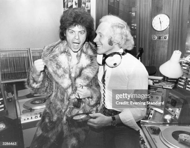 Glam pop star Gary Glitter, left, with DJ David 'Diddy' Hamilton. Glitter is making his first national broadcast since his successful throat...