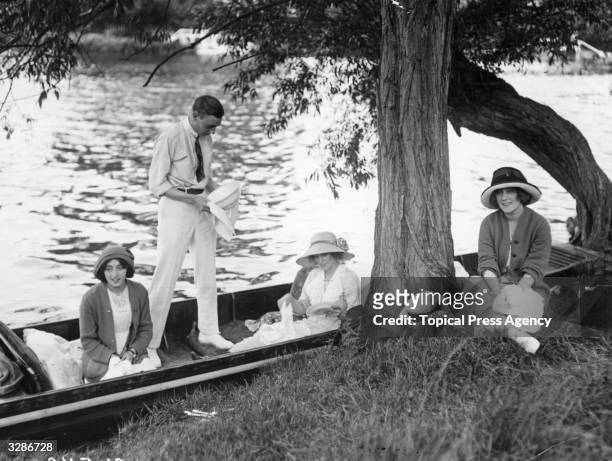 Phillys Monkman and friends wash up after a punting picnic near Boulters Lock, on Ascot Sunday.