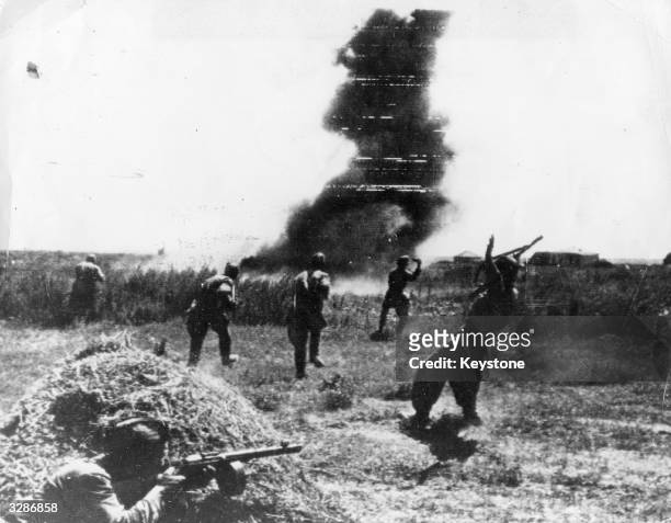 Soldiers face an explosion in the thick of the battle for Stalingrad. One soldier has been hit by a sniper.