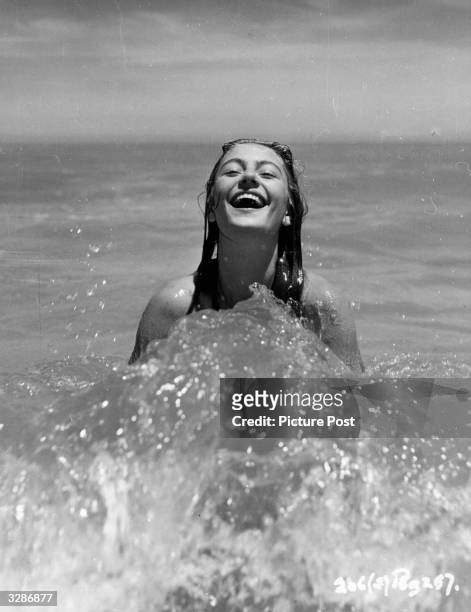 Anouk Aimee French film star, enjoying a splash in the sea.
