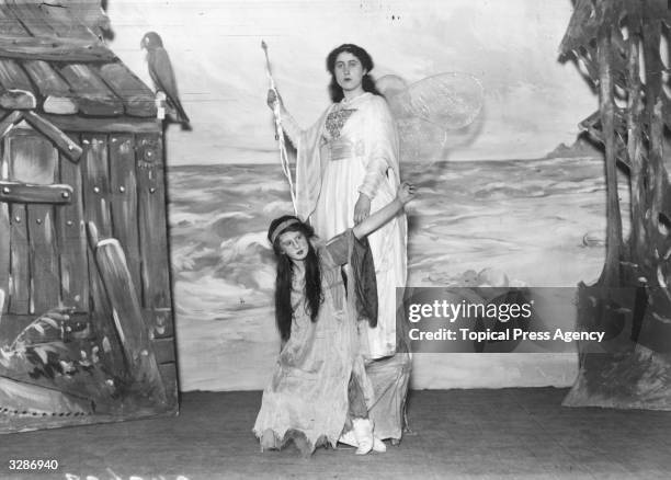 Lord and Lady Willoughby de Broke's pantomine 'Robinson Crusoe' at Compton Verney: 'Fairy of the Island' poses with the 'Spirit of the Storm' .