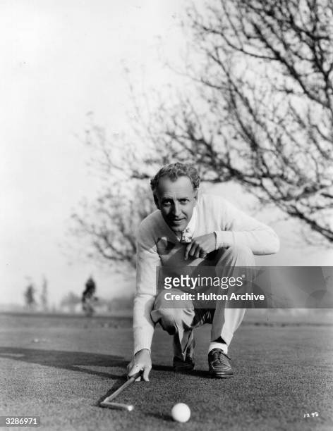 Otto Kruger, ace golfer and Hollywood film actor signed by MGM, lining up a short put.
