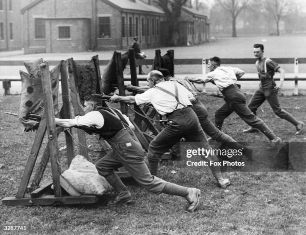 Recruits at bayonet practice at the Depot Barracks of the West Yorkshire Regiment at York. After training they will join the battalion at Catterick.