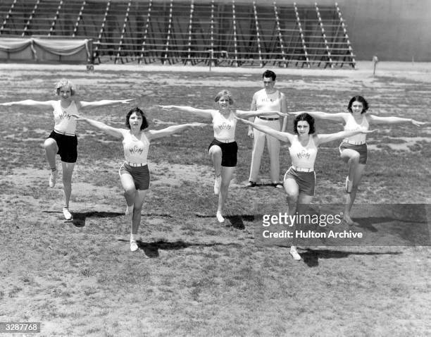 Gwen Lee with Ruth Holly, Blanche Le Clair, Raquel Torres and Fay Webb are all under the instruction of Dr Anderson, in the background, who exercises...