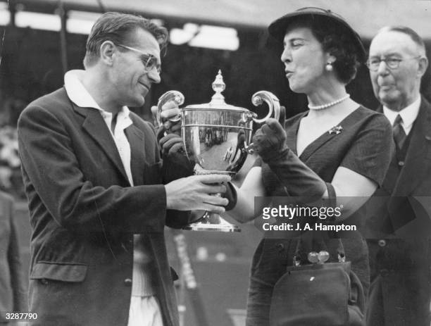Marina, Duchess of Kent, presents the men's singles trophy to Czech-born Egyptian Jaroslav Drobny at the Wimbledon Lawn Tennis Club after he beat Ken...