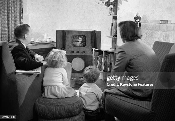 Family watching television at home.