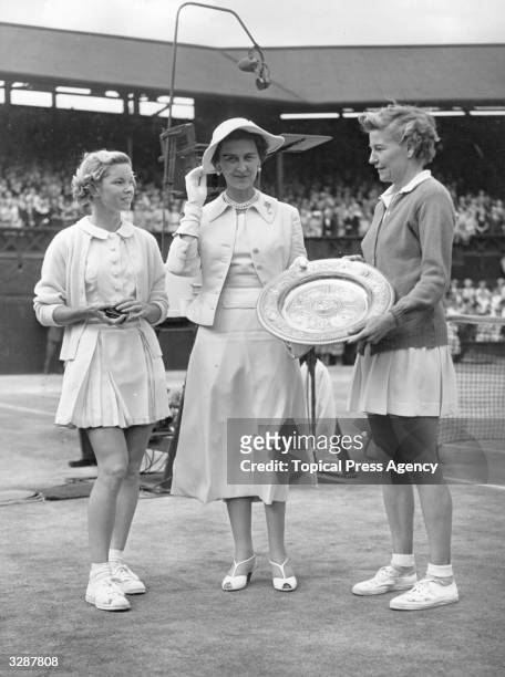Marina, Duchess of Kent, born Princess Marina of Greece and Denmark, presents the Wimbledon women's singles trophy to Louise Brough of the USA after...