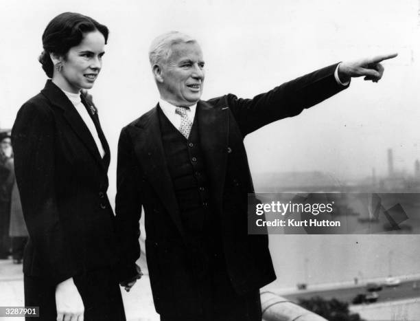 Actor and director Charlie Chaplin on the roof of the Savoy Hotel with his wife, Oona. Original Publication: Picture Post - 6099 - Chaplin D P - pub....