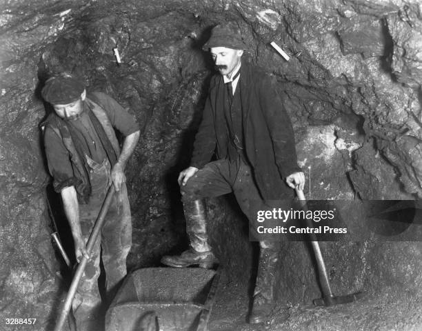 Tin miners at work down the pit in Cornwall.