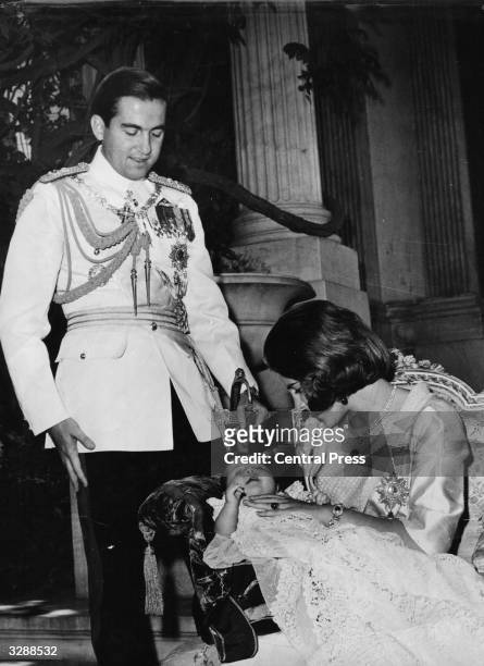 King Constantine II and Queen Anne-Marie of Greece at the christening ceremony for their daughter Princess Alexia, at the royal palace at Athens.