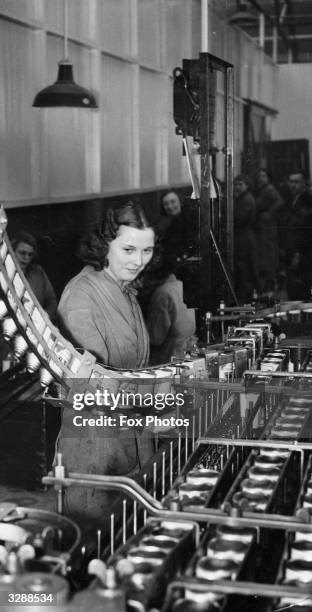 New innovation - canned beer - is rapidly becoming very popular. Here at the Acton factory of a well known brewer the canning process is well under...