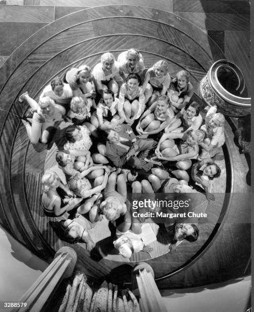 Edmund Lowe, the Hollywood actor surrounded by a bevy of young actresses.