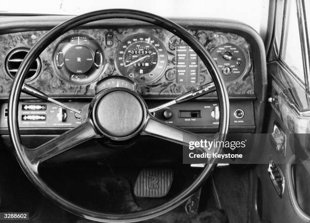 Rolls Royce steering wheel and walnut dashboard.