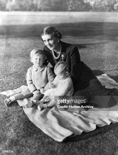 The Duchess Marina of Kent , sitting on a rug on the lawn with her two children, Prince Edward and Princess Alexandra at 'Coppins' in Iver,...