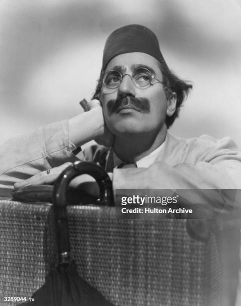 Julius 'Groucho' Marx , one of the Marx Brothers, a team of American film comedians. He is wearing a fez for his role in 'A Night In Casablanca', a...