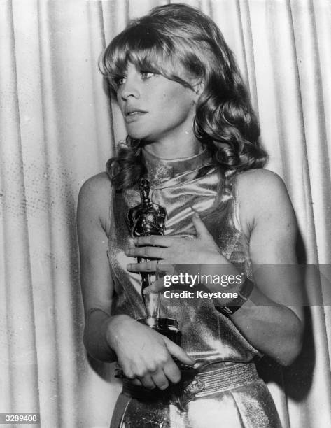 British actress Julie Christie holds the Academy Award she won for her role in the film 'Darling' , at the awards reception at the Civic Auditorium...