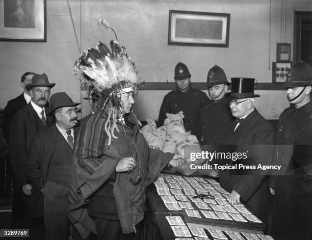 Sir George Royle, president of the New Tabernacle Sick and Provident Society, dressed as Native American Iroquois Indian Chief Sunshine, receives the...