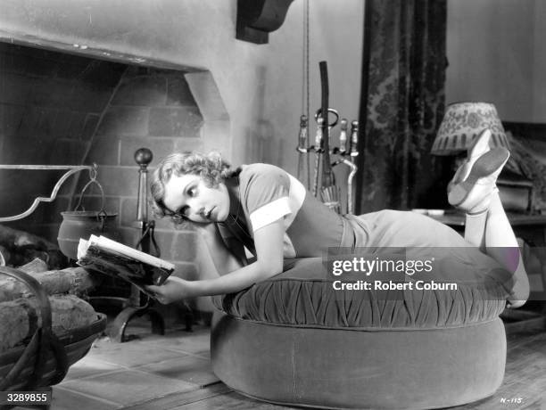 Dorothy Lee the American leading lady of the 30's . Dorothy is so absorbed in her book that she has not noticed that the fire has gone out.