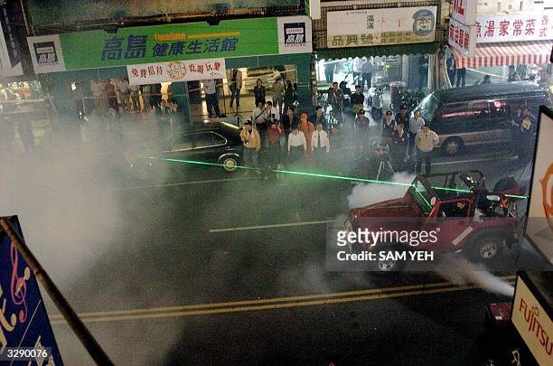 Forensic scientists use a laser to determine the point where a bullet was fired at the jeep in which President Chen Shui-bian was shot in Tainan, 09...