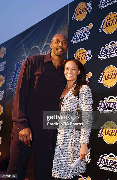 Karl Malone of the Los Angeles Lakers and his wife Kay arrive at the Lakers' Youth Fundraiser held at the Barker Hangar on April 8,2004 in Santa...