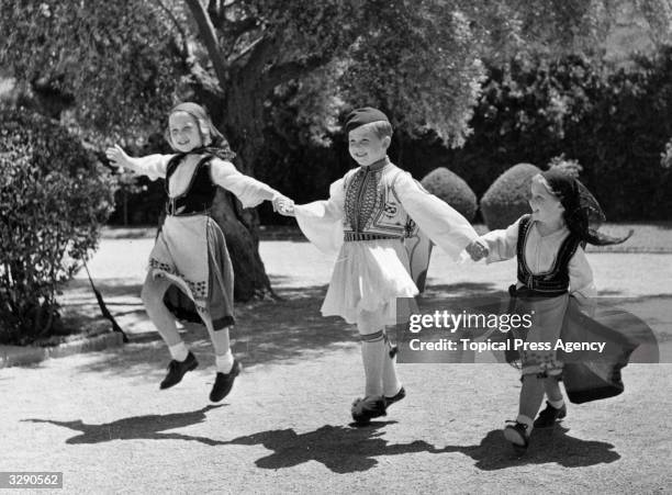 From left, Princess Sofia of Spain, , Crown Prince Constantine II of the Hellenes, , and Princess Irene of Greece, in the garden of their home in...