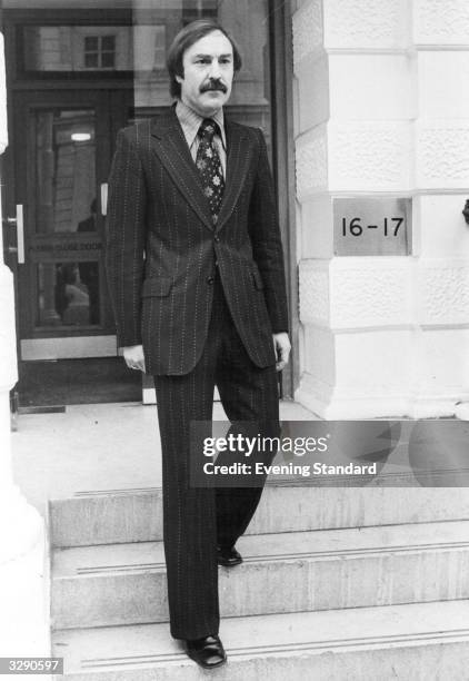 Jimmy Greaves leaves the Lancaster Gate headquarters of Football Association, wearing a suit.
