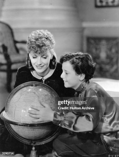 Scene from 'Anna Karenina', featuring Greta Garbo as the heroine and Freddie Bartholomew as her son, looking at a globe of the world. The film was...