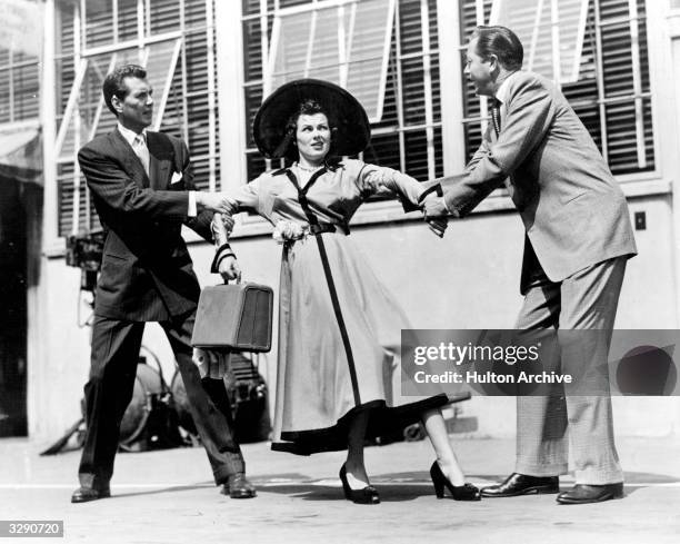 Robert Hutton and Robert Young fight over Barbara Hale in a scene from the film 'And Baby Makes Three', directed by Henry Levin for Columbia.