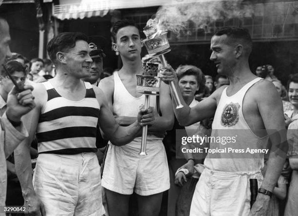 The Olympic flame is passed by N J Bignal at the 1948 Olympiad.