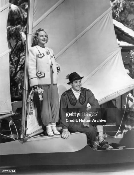 Skating star Sonja Henie and American actor Robert Cummings on board a yacht in the spy comedy 'Everything Happens At Night', directed by Irving...