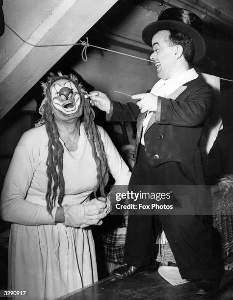 Harti, a clown from the Harringay circus who has dressed as mother, is made up by Koko, his dwarf colleague from the circus.