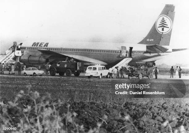 The hijacked Boeing 707 of Lebanon's Middle East Airlines, with the safety chutes down, at Lydda Airport, Israel. The plane was hijacked by a...