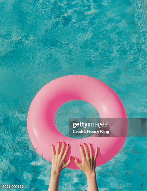 hands on inflatable ring - float stockfoto's en -beelden