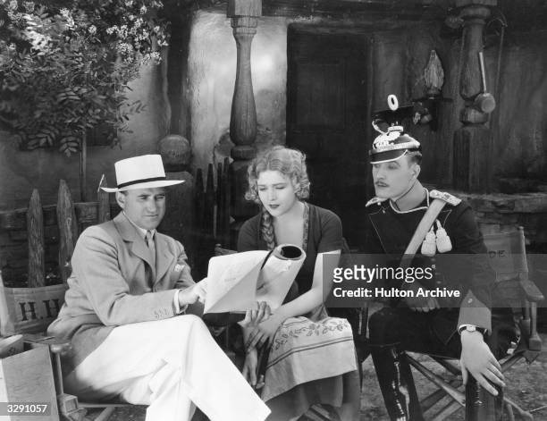 Austro-Hungarian actress Vilma Banky and her British co-star Walter Byron sit down with producer Samuel Goldwyn to discuss the script of film 'The...