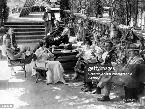 Australian actress Mae Busch with Creighton Hale , Lew Cody and director Robert Z Leonard during a break in the filming of 'The Comedian'.