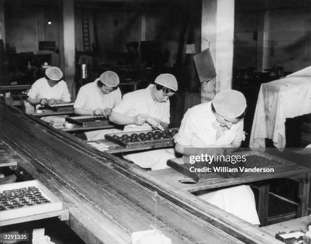 Workers decorating chocolates at the Meltis factory in Bedford.