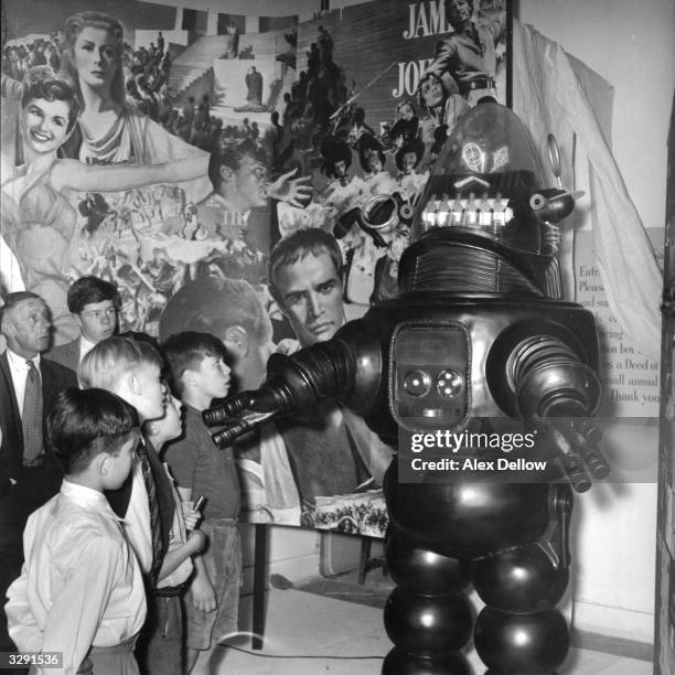 Display featuring movie and television character Robbie The Robot from 'Forbidden Planet' enthralling a group of youngsters. Original Publication:...