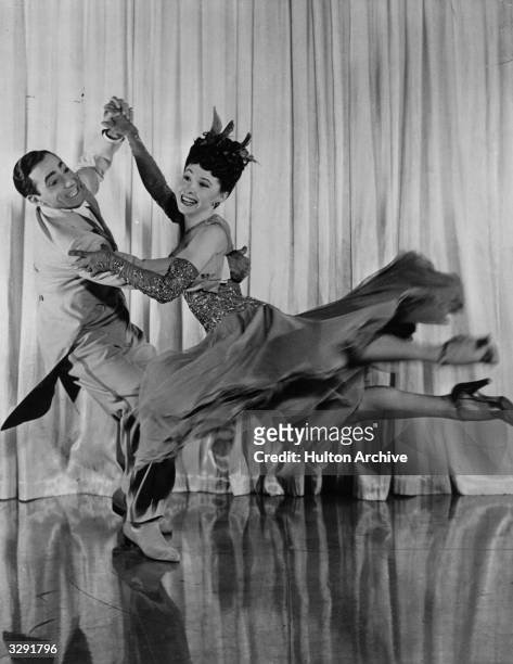 Dancing couple Tony and Sally De Marco perform a daring spin in a scene from the 20th Century Fox music and dance extravaganza 'Greenwich Village',...
