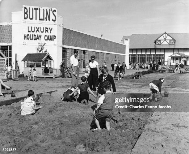 Children playing in the sandpit at a Butlin's holiday camp.