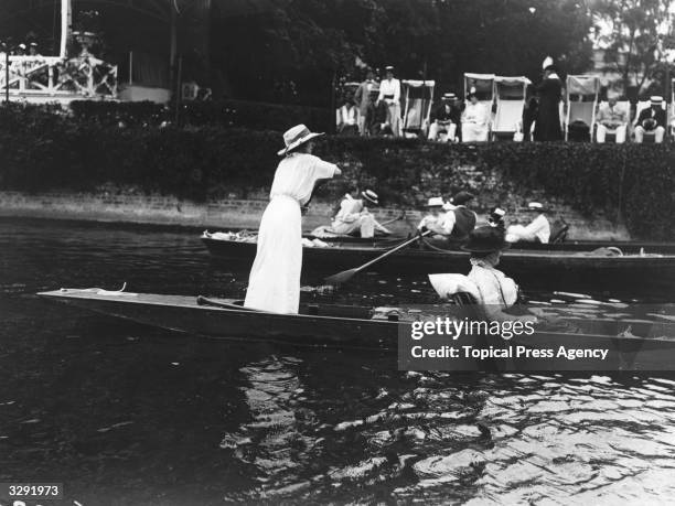 Woman punting on the Thames at the Henley Regatta.