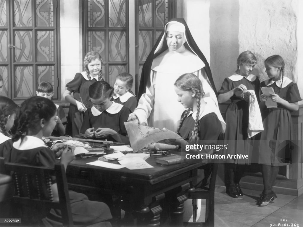 Nun Teaching With Ruler A nun teaching a group of schoolgirls in a scene from the David O ...