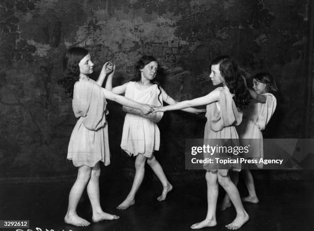 Pupils of Miss Morris, London's youngest actress, manageress, being taught a dance.