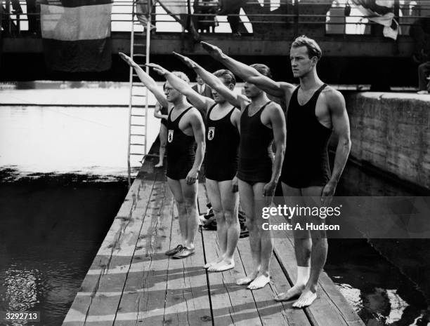 Members of the German swimming team give the Nazi salute during the playing of the German National Anthem at the PLA Swimming Club's Annual Open-Air...