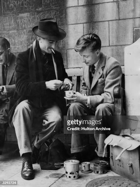 John Lester, left, and Raymond Croft make themselves a hot drink while waiting outside the public entrance to the House of Commons to hear the debate...