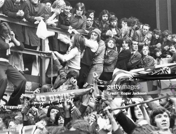 Rowdy Manchester United football fans take to the stands as they sense the oncoming defeat of their team by West Ham at the Upton Park football...