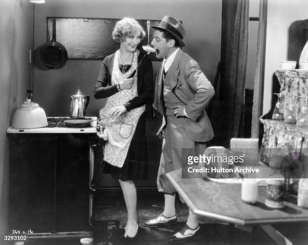 Director A Edward Sutherland jokes around with actress Gwen Lee on the set of the MGM silent comedy 'The Baby Cyclone'.