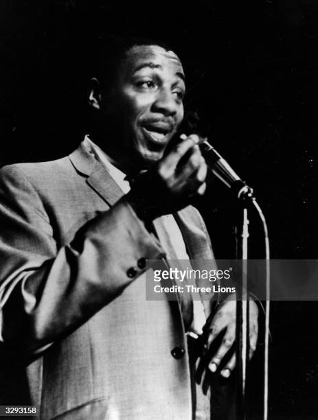 Black comedian Dick Gregory at the microphone, 1962.