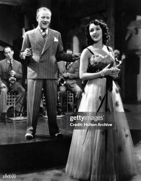 Bandleader Jack Hylton and singer Pat Kirkwood star together in the wartime comedy 'Band Wagon', directed by Marcel Varnel for Gainsborough.