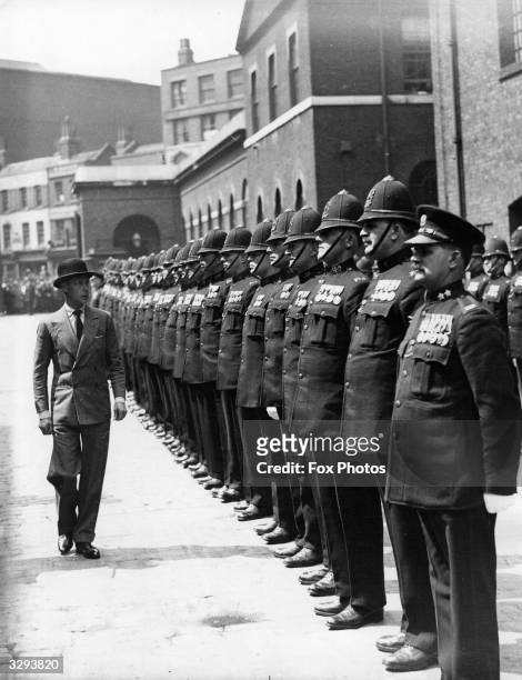The Duke of Windsor, , as Edward, Prince of Wales, inspects a parade of Port of London Authority policemen during a visit to London docks. He...